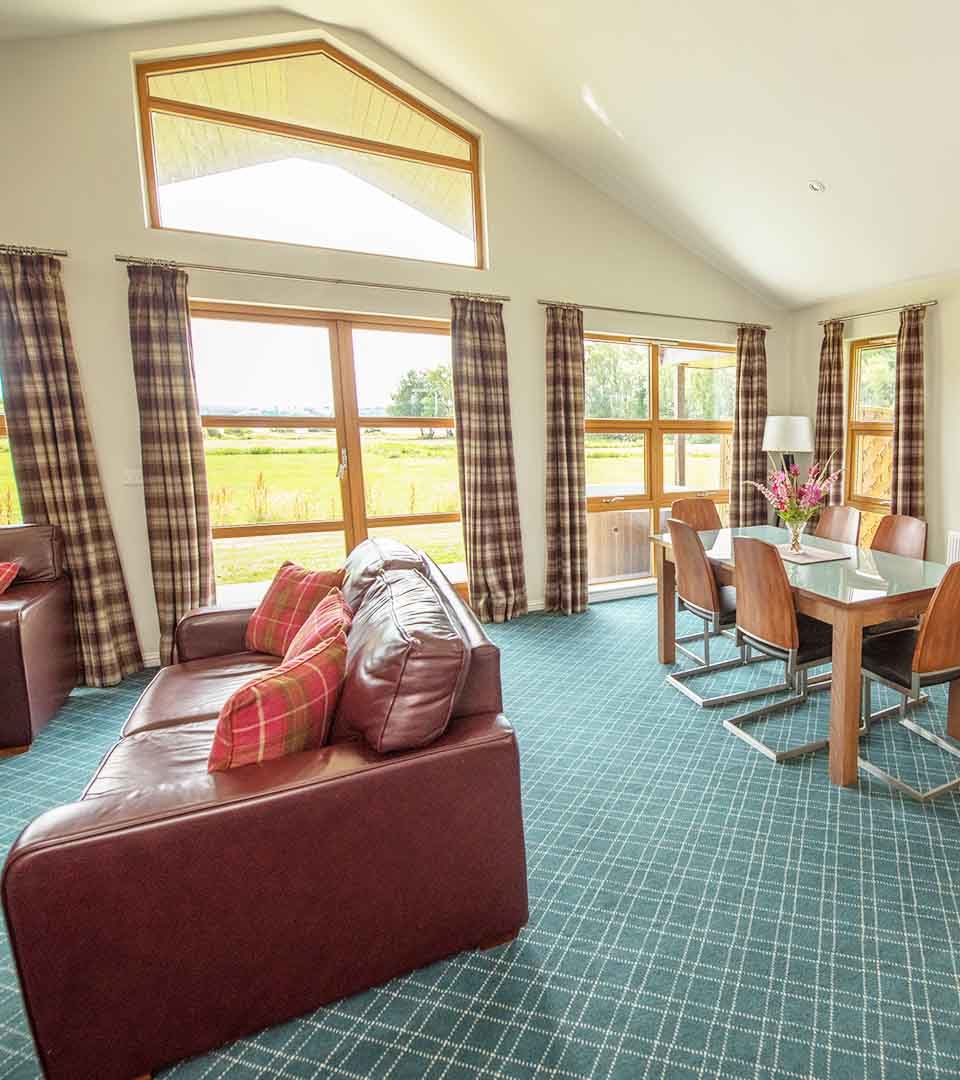 An open plan living area in a Chalet at Loch Lomond Waterfront with views over Loch Lomond