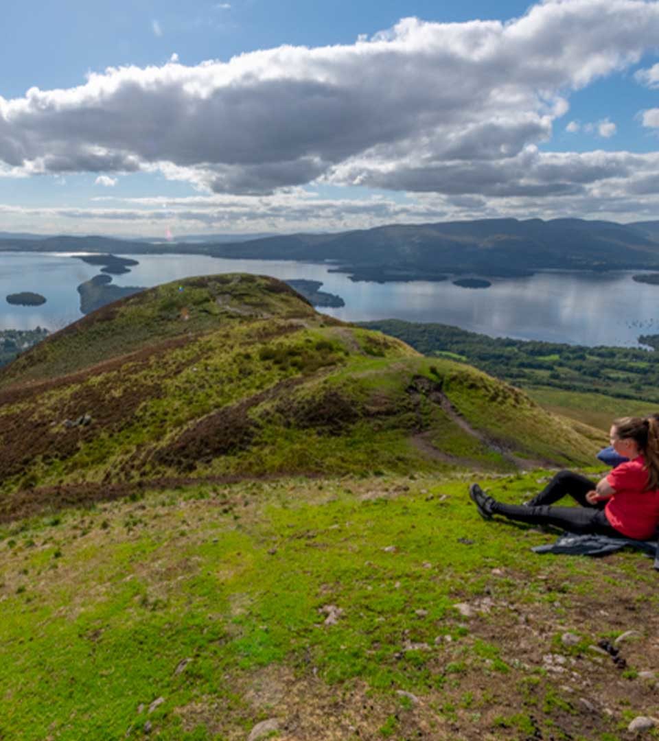 Hikers on the top of Conic Hill enjoying holiday breaks in scotland