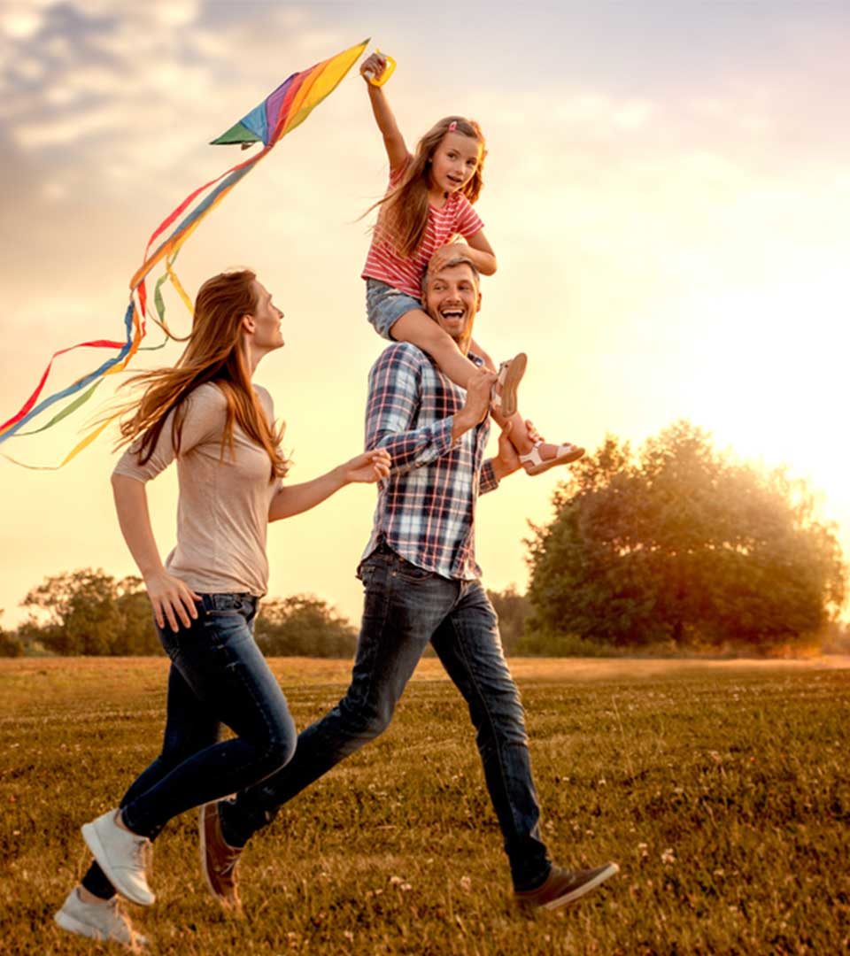 A family enjoying a walk out and playing with a kite