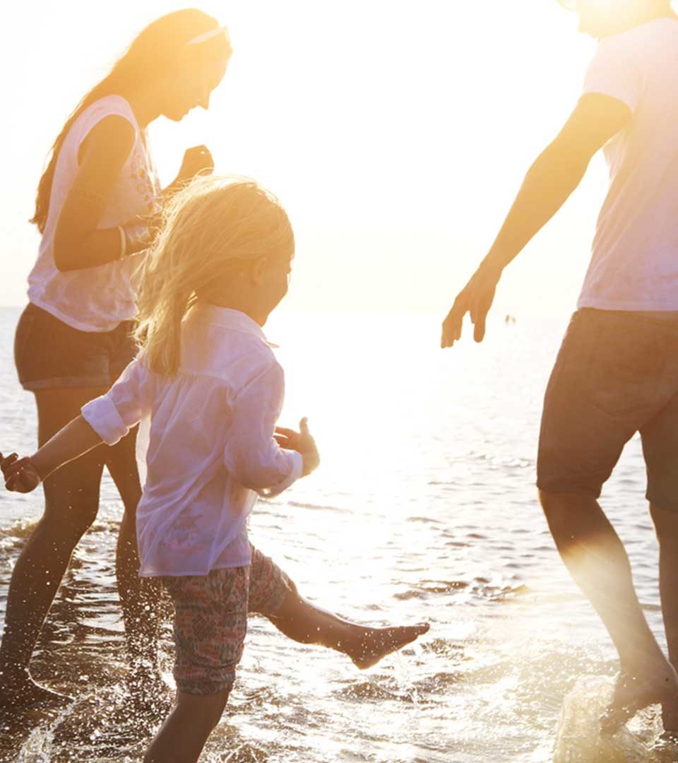 A family splashing in water