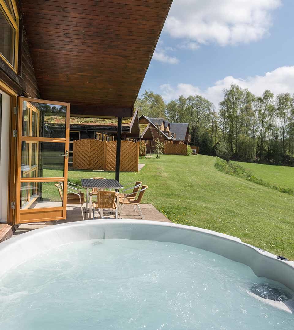 The hot tub outside the Drummond / Honeymoon Suite chalet at Loch Lomond Waterfront in Balmaha