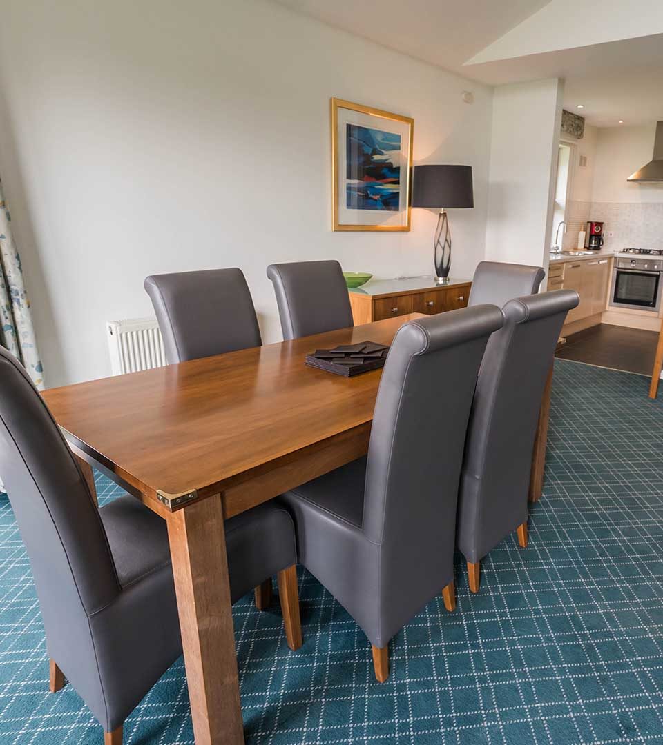 The dining area in the Drummond / Honeymoon Suite chalet at Loch Lomond Waterfront in Balmaha