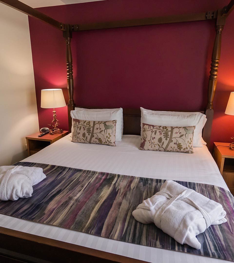 The four poster bed in the Drummond / Honeymoon Suite chalet at Loch Lomond Waterfront in Balmaha