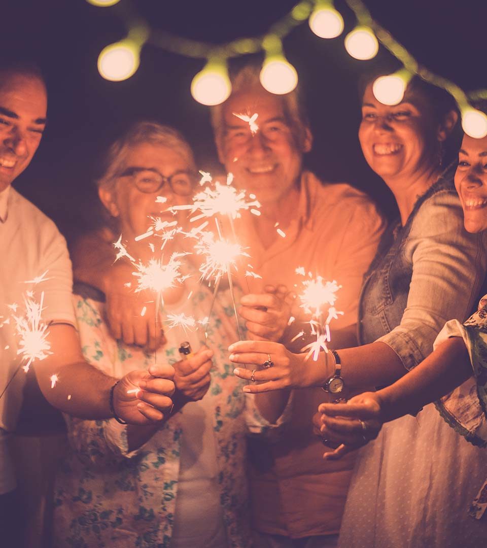 A family celebrate new year with drinks and sparklers