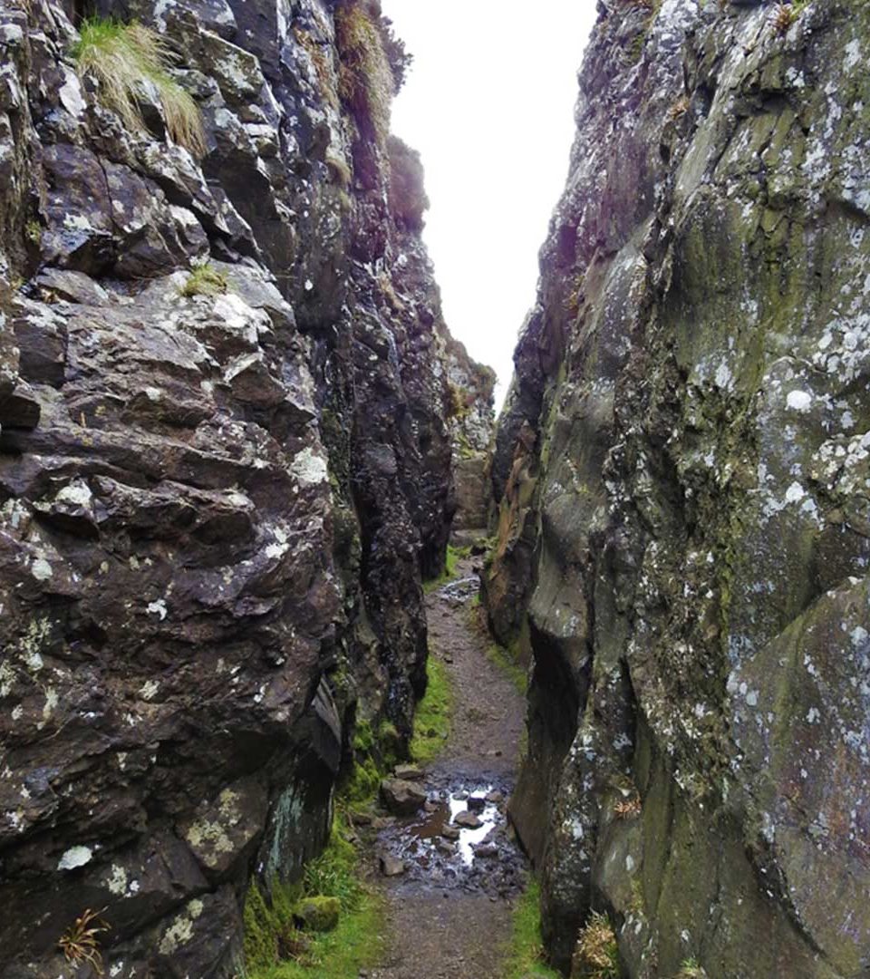 Walking through the split rock of the Whangie