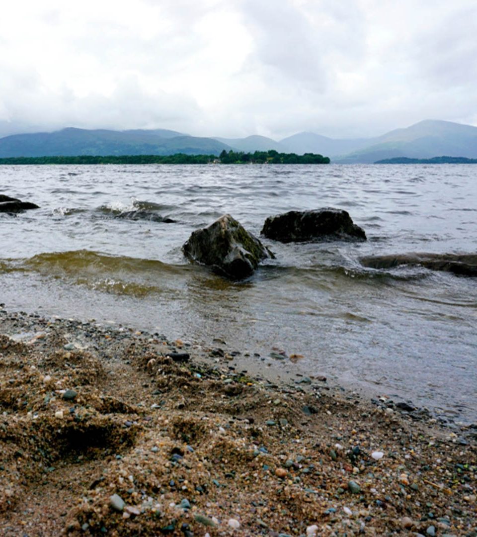 A view over the water from a beach on Loch Lomond on a Balmaha Walk