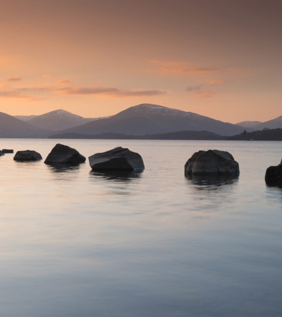 Milarochy Bay at Loch Lomond with a row of stones going out into the water