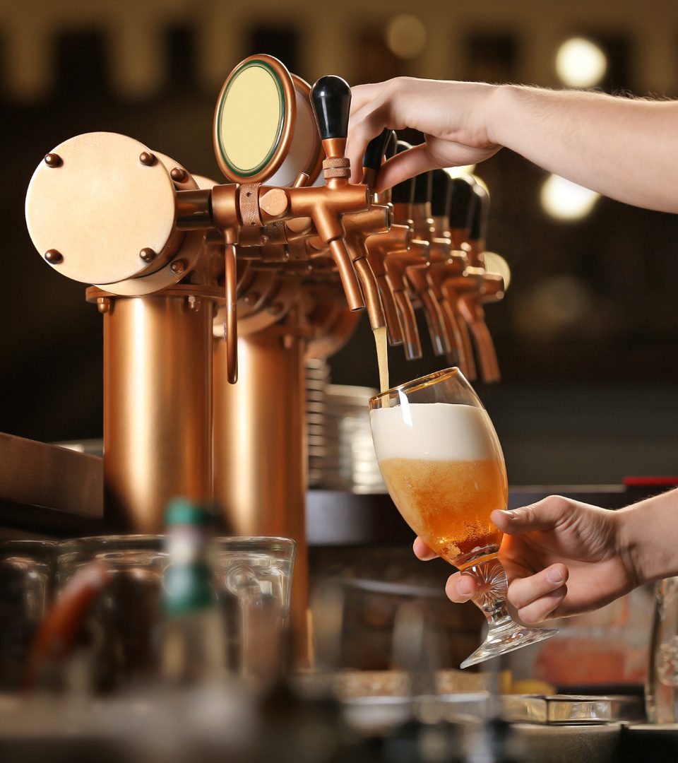 Bar staff pouring a beer