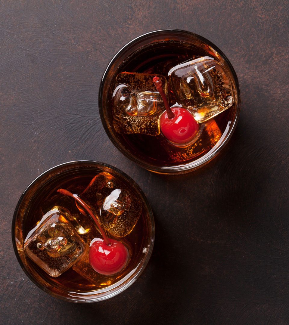 Two Manhattan whisky cocktails viewed from above