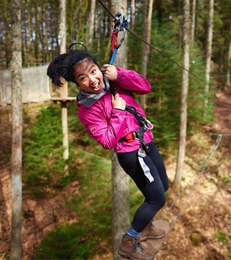 Girl on high wire at Go Ape outdoor adventure centre