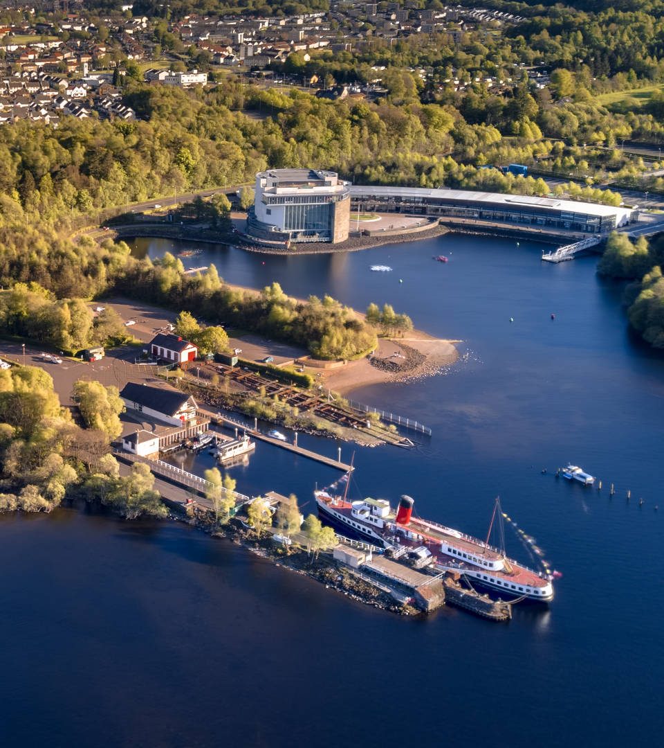 Aerial view of Loch Lomond Shores centre and Maid of Loch paddle steamer in Balloch, Scotland