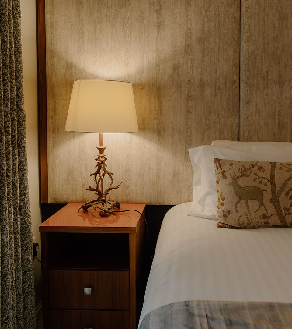 A bed detail in a chalet at Loch Lomond Waterfront luxury lodges in Balmaha