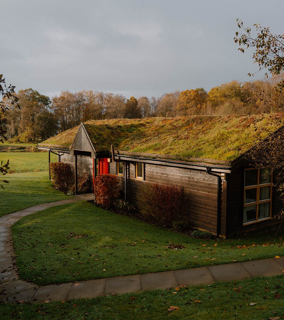 The exterior of a chalet at Loch Lomond Waterfront luxury lodges in Balmaha