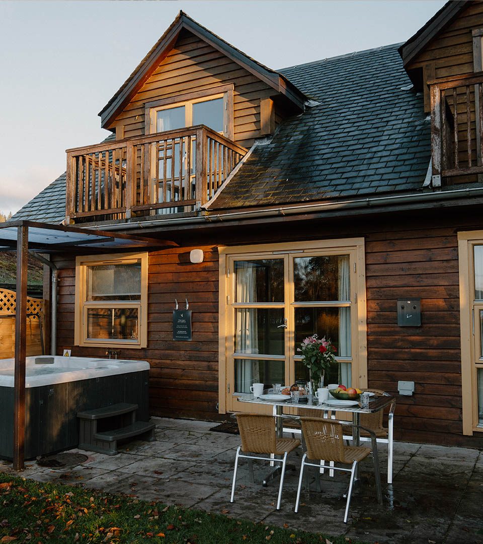 The exterior of a Diamond Lodge at Loch Lomond Waterfront luxury lodges in Balmaha