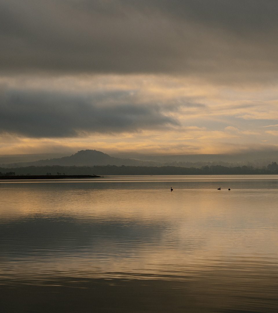 A view at sunset across Loch Lomond at Loch Lomond Waterfront luxury lodges in Balmaha