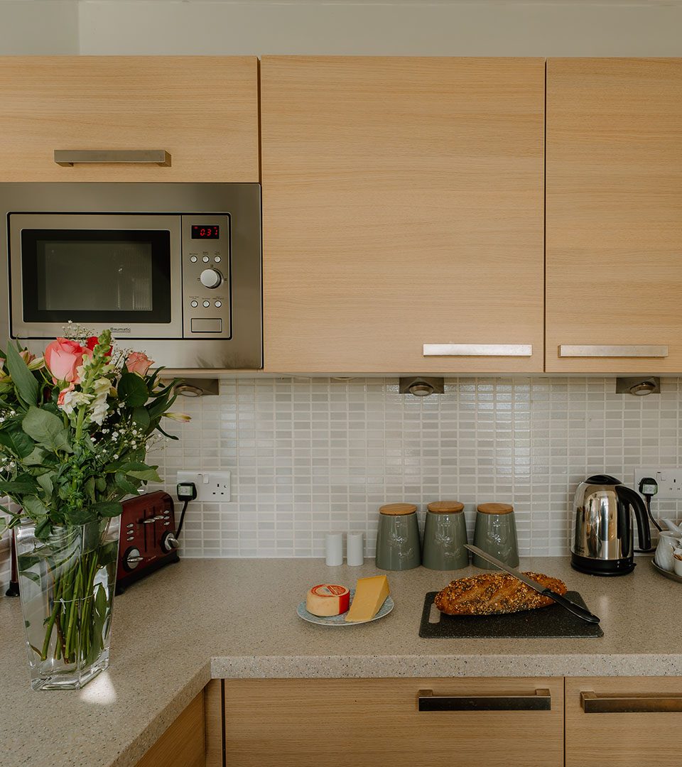 A kitchen in a lodge with freshly bake bread at Loch Lomond Waterfront luxury lodges in Balmaha