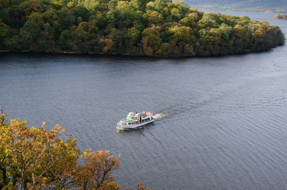 Cruise boat heading to Balmaha at Loch Lomond. Aerial view looking down on the loch. 