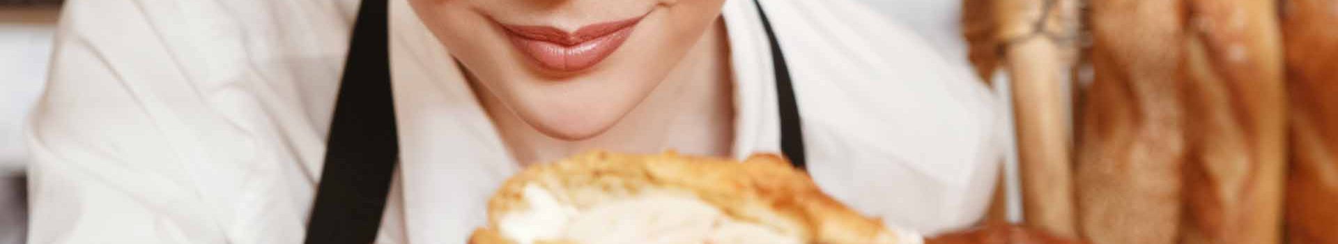 A lady looks at some freshly baked goods.