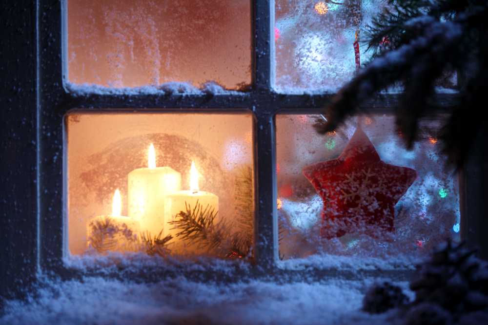 Frosted window with Christmas candles 
 decoration