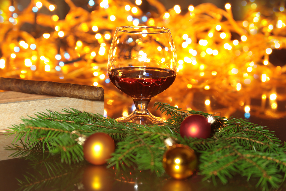 Christmas decoration. Glasses of brandy or cognac on the wooden table.