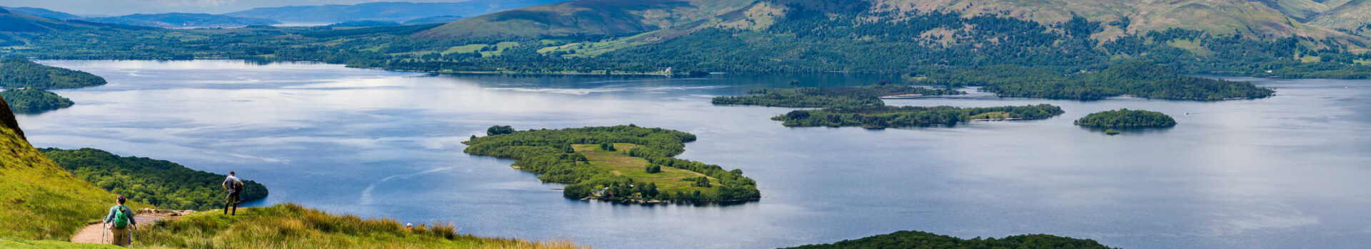 Hikers descending Conic Hill towards Loch Lomond